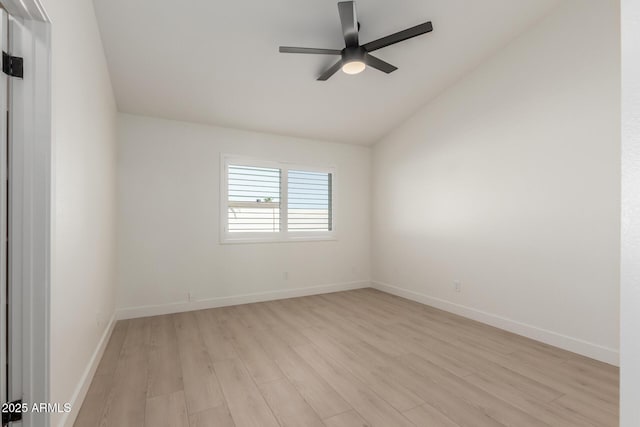 spare room featuring light wood-type flooring, ceiling fan, and lofted ceiling