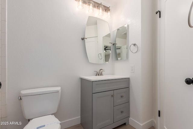 bathroom with toilet and vanity