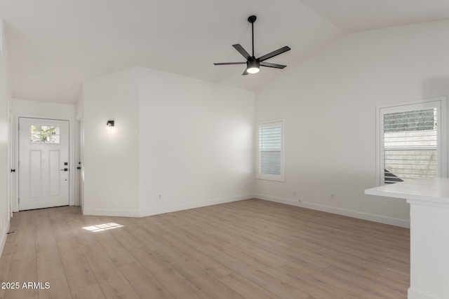 unfurnished living room with ceiling fan, light wood-type flooring, and high vaulted ceiling