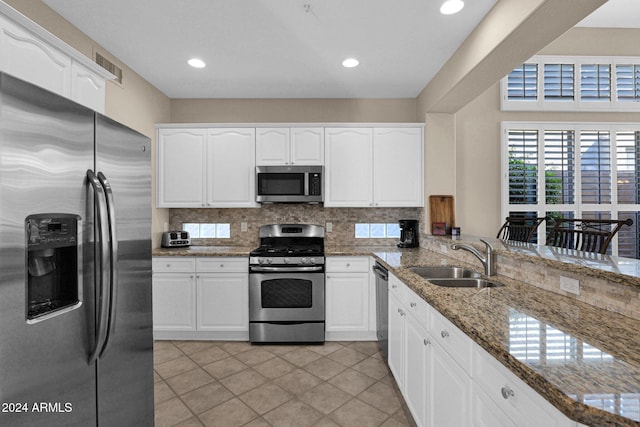 kitchen featuring sink, white cabinets, and appliances with stainless steel finishes