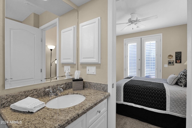 bathroom with ceiling fan, french doors, and vanity