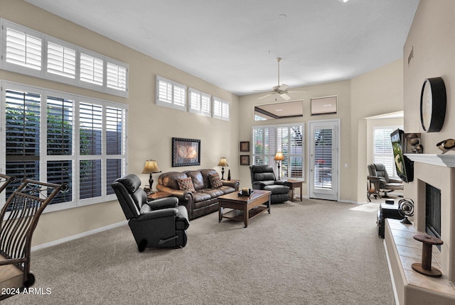 living room with ceiling fan, a healthy amount of sunlight, and light colored carpet