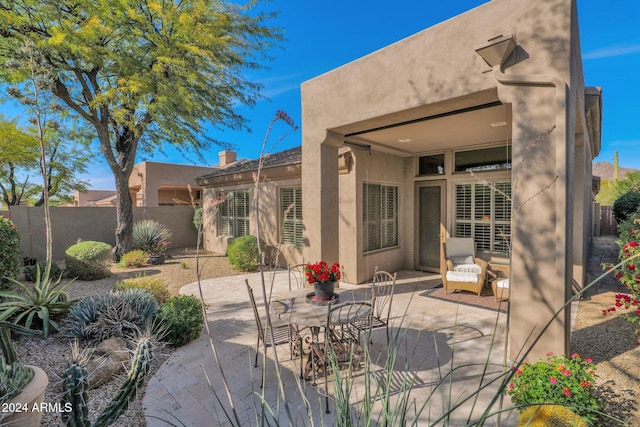 back of house with a patio