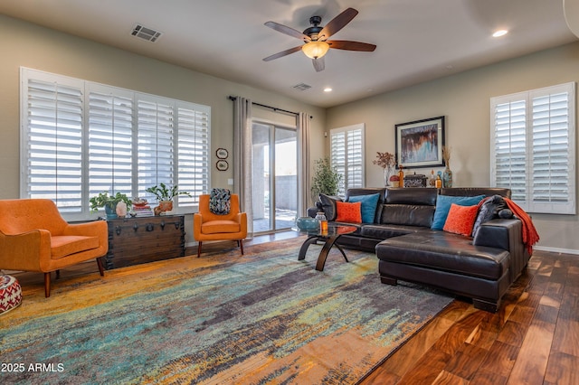 living room with ceiling fan, dark hardwood / wood-style flooring, and a healthy amount of sunlight