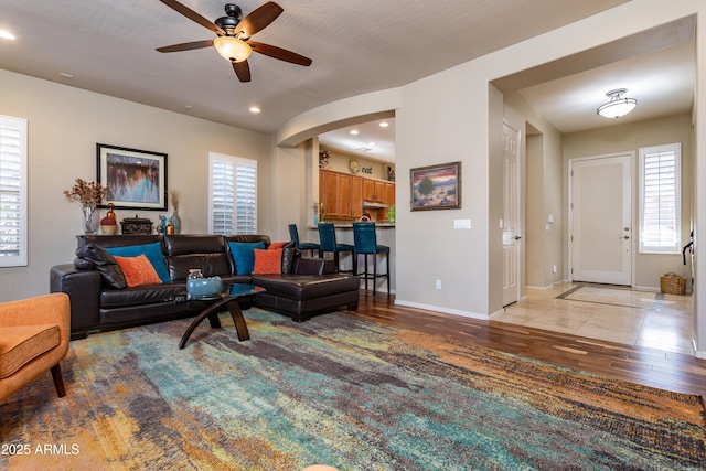 living room featuring ceiling fan, a healthy amount of sunlight, and light hardwood / wood-style floors