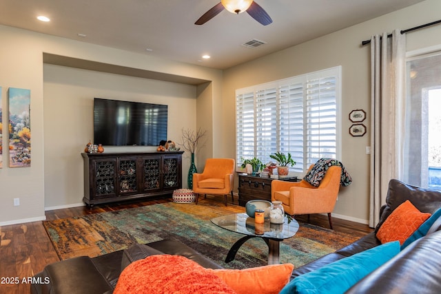 living room with dark hardwood / wood-style floors and ceiling fan