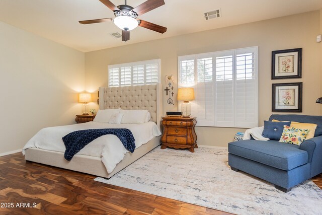 bedroom with multiple windows, ceiling fan, and dark hardwood / wood-style flooring