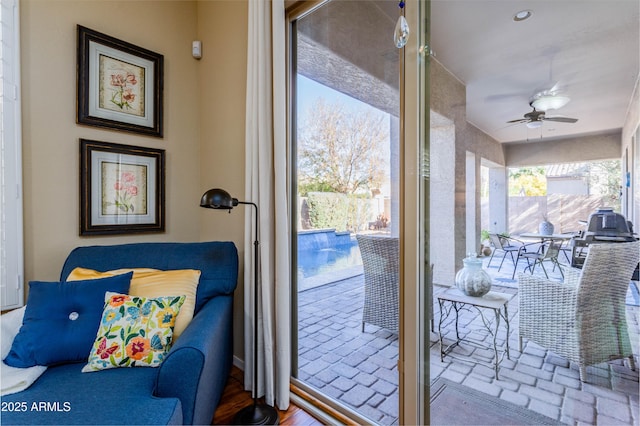 entryway with wood-type flooring and ceiling fan