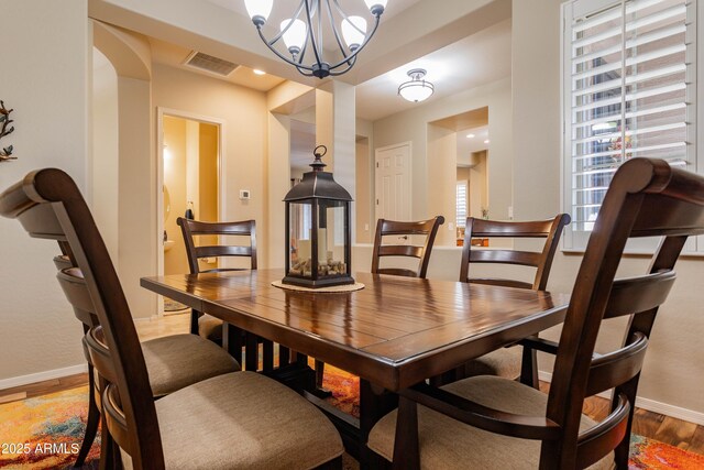 dining room with a chandelier and hardwood / wood-style floors