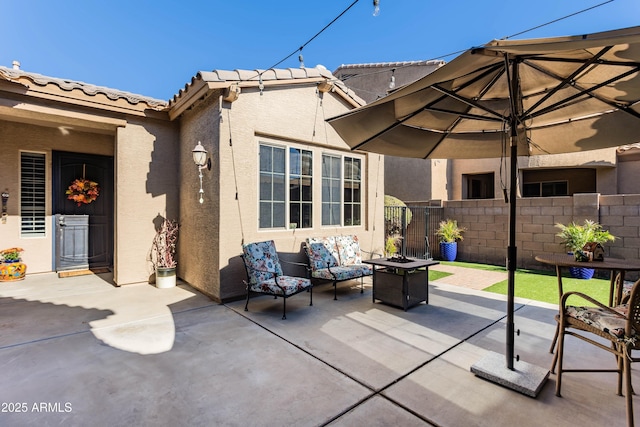 view of patio featuring an outdoor living space with a fire pit