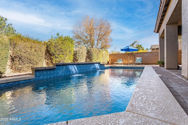 view of pool featuring pool water feature and a patio