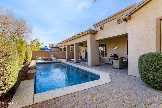 view of pool with pool water feature and a patio area