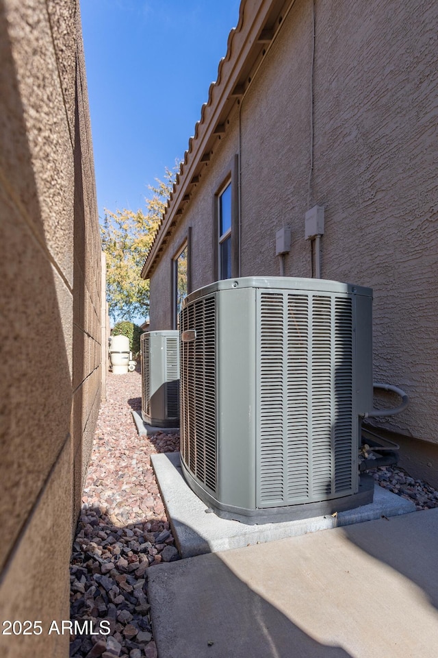 view of side of property with central air condition unit