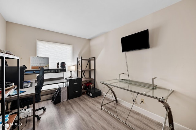 office space with light wood-style floors and baseboards