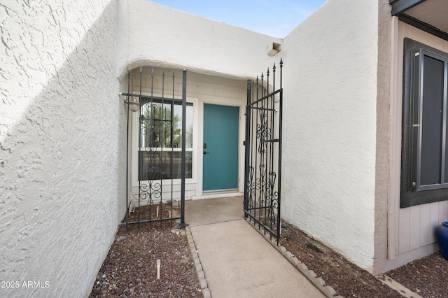 view of exterior entry with stucco siding