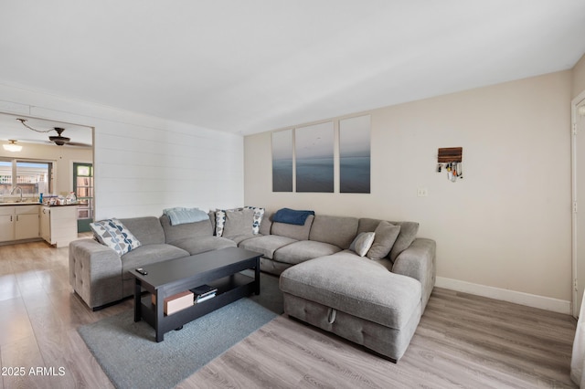 living area featuring light wood-type flooring and baseboards