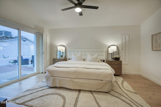 bedroom featuring baseboards, access to outside, a ceiling fan, and wood finished floors