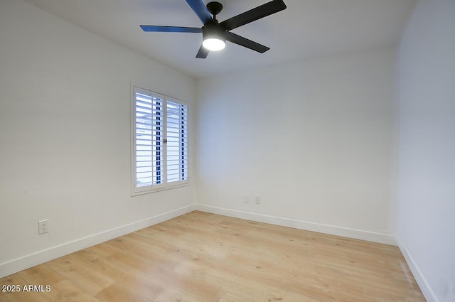 empty room featuring baseboards, light wood-style flooring, and a ceiling fan