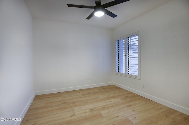 empty room featuring a ceiling fan, baseboards, and wood finished floors