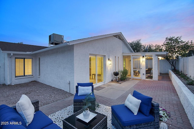 back of house with stucco siding, fence, cooling unit, and a patio area