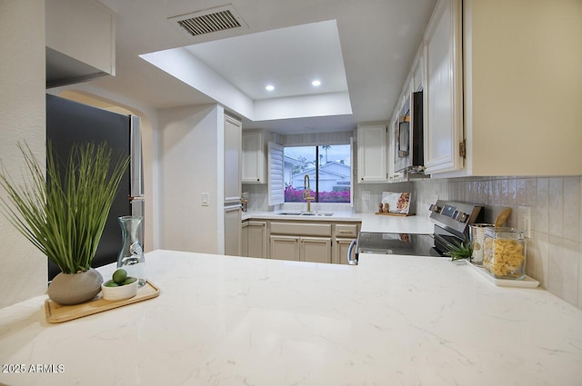 kitchen featuring a sink, tasteful backsplash, appliances with stainless steel finishes, visible vents, and recessed lighting