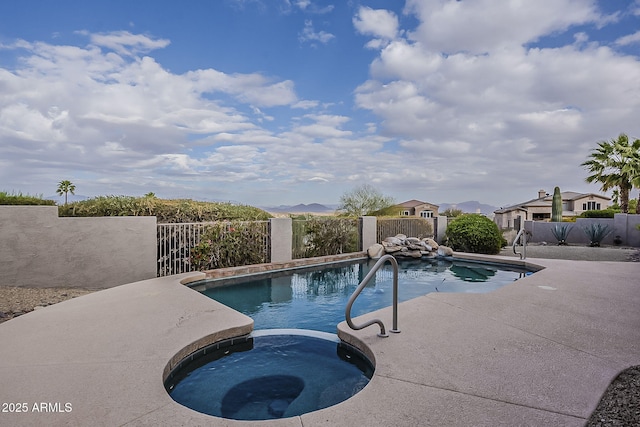 view of pool with a fenced in pool, an in ground hot tub, and fence