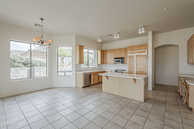 kitchen with visible vents, appliances with stainless steel finishes, a breakfast bar area, and light countertops