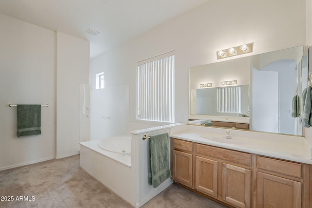 bathroom featuring vanity, a garden tub, and visible vents