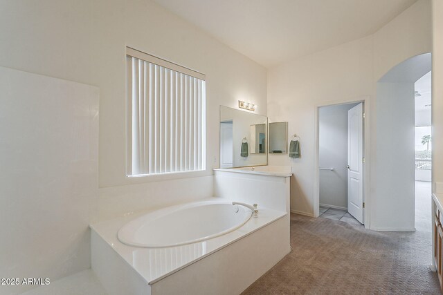 bathroom featuring vanity and a garden tub