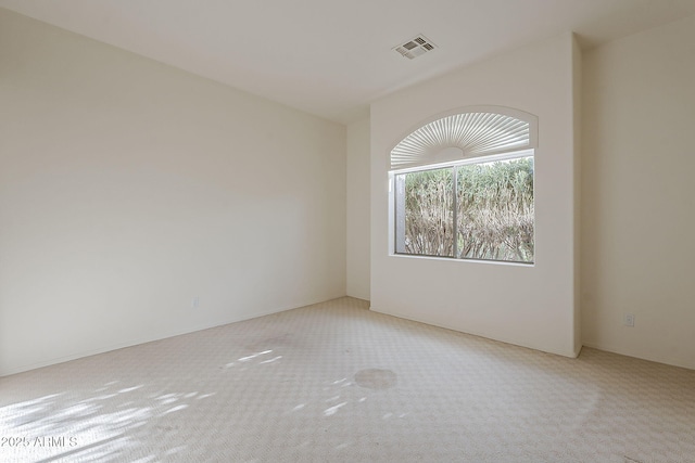 empty room featuring visible vents and carpet flooring