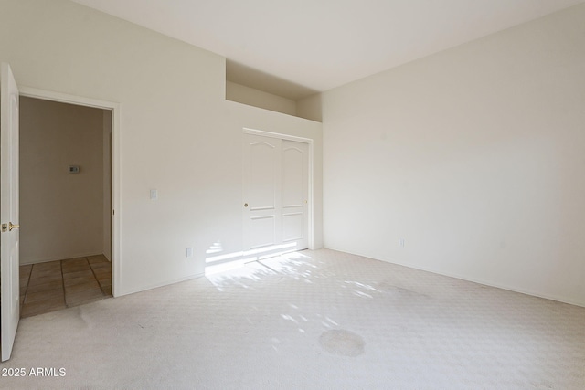 unfurnished bedroom with a closet and carpet floors