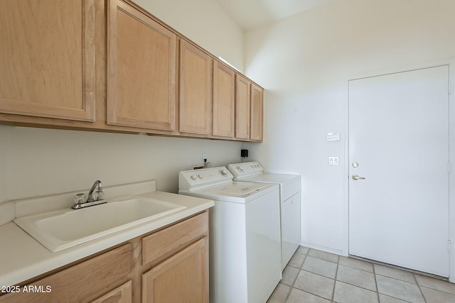 laundry room featuring washer and dryer, light tile patterned floors, cabinet space, and a sink