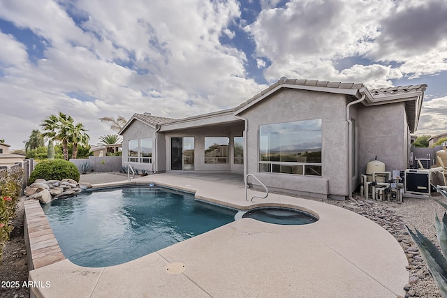 view of pool with a patio area, a pool with connected hot tub, and a fenced backyard