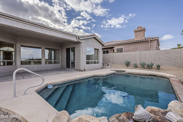 view of swimming pool featuring a patio, fence, and a fenced in pool