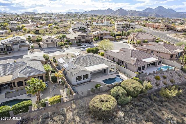 drone / aerial view featuring a residential view and a mountain view