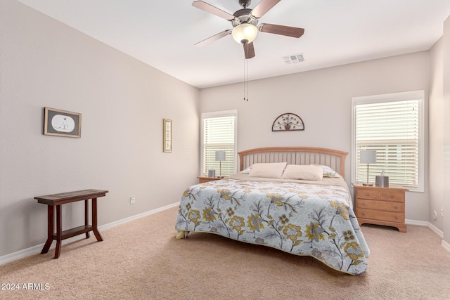 bedroom featuring light carpet and ceiling fan