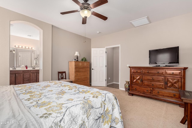 carpeted bedroom featuring connected bathroom and ceiling fan