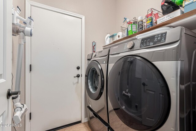 laundry room with separate washer and dryer and light tile patterned floors