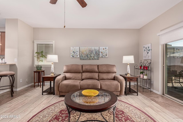 living room with light wood-type flooring and ceiling fan