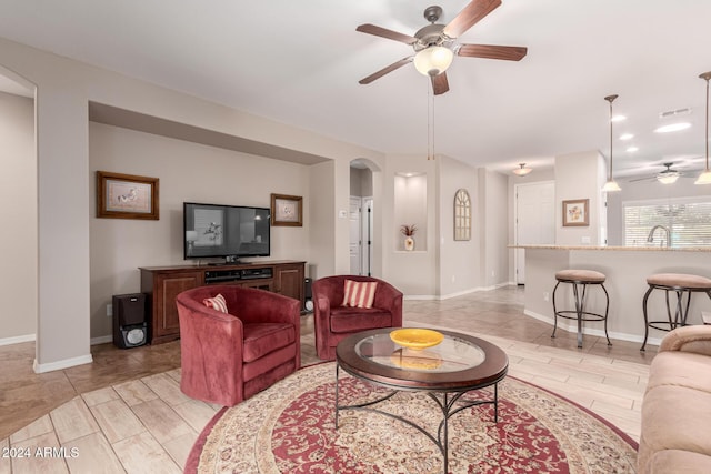 living room with sink and ceiling fan