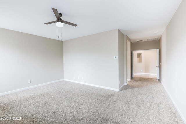 empty room featuring baseboards, visible vents, ceiling fan, and carpet