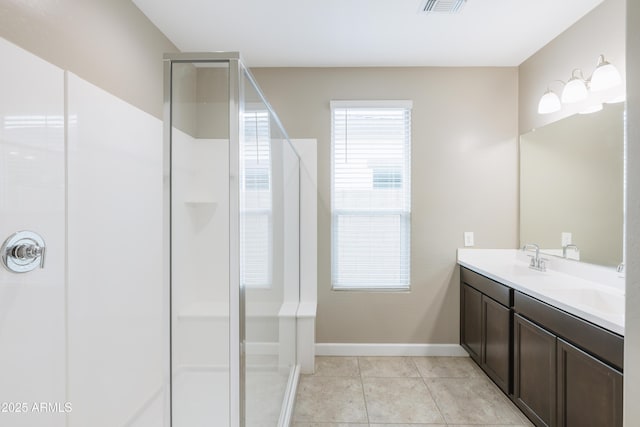 full bathroom featuring an enclosed shower, a sink, tile patterned flooring, baseboards, and double vanity