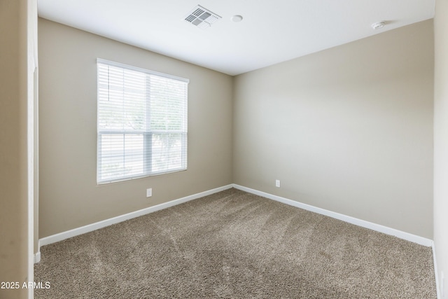 carpeted empty room with baseboards and visible vents