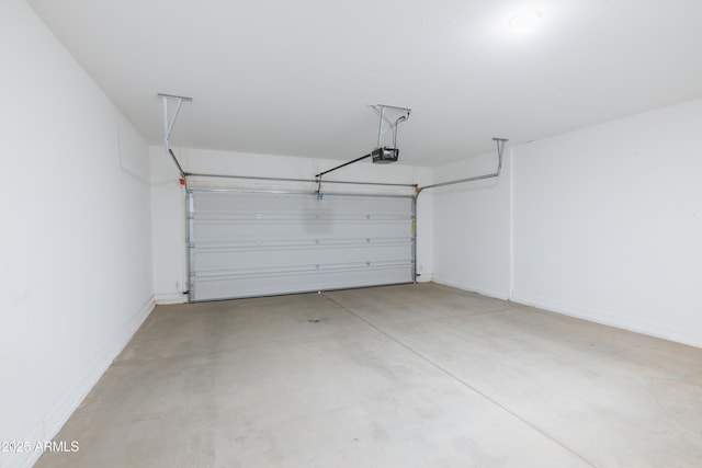 garage featuring a garage door opener and baseboards