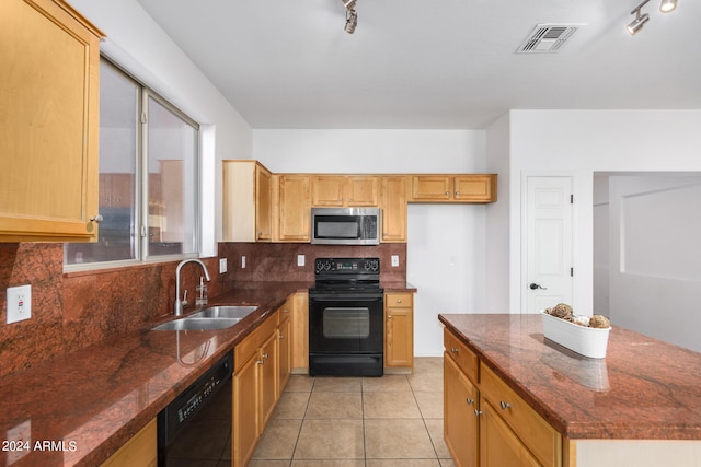 kitchen with black appliances, tasteful backsplash, dark stone counters, and sink