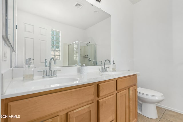 bathroom featuring vanity, toilet, tile patterned floors, and walk in shower