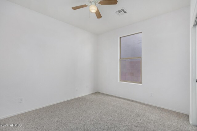 empty room with light colored carpet and ceiling fan