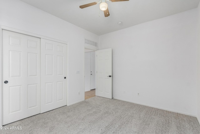 unfurnished bedroom featuring ceiling fan, a closet, carpet flooring, and baseboards