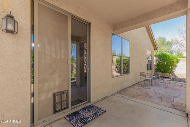 entrance to property with a patio area and stucco siding