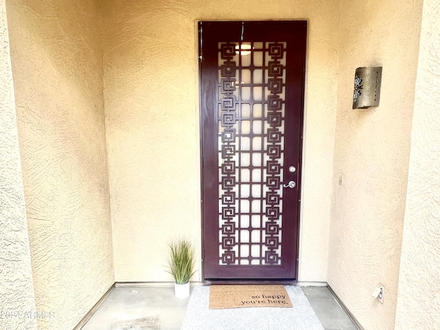 doorway to property with stucco siding